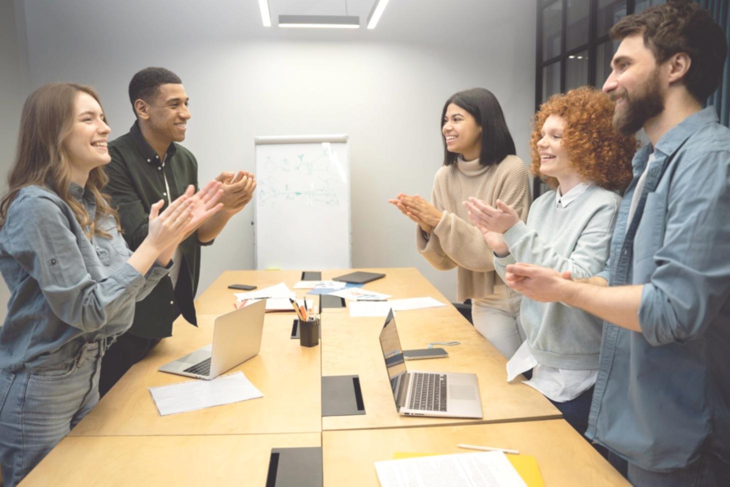 Hands writing financial goals and budget calculations in notebook